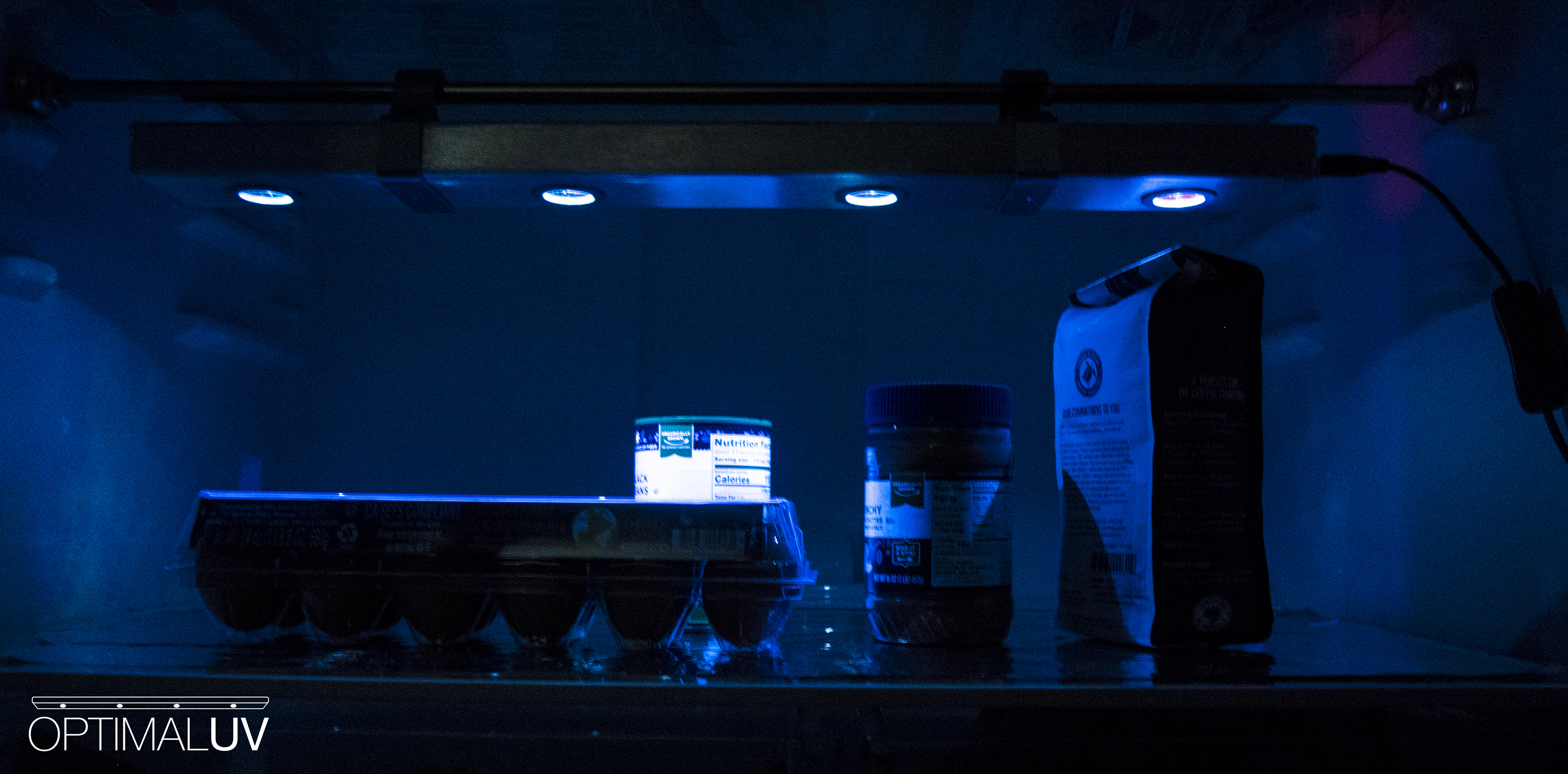 OptimalUV bar in operation, UVC LEDs glowing over refrigerated food